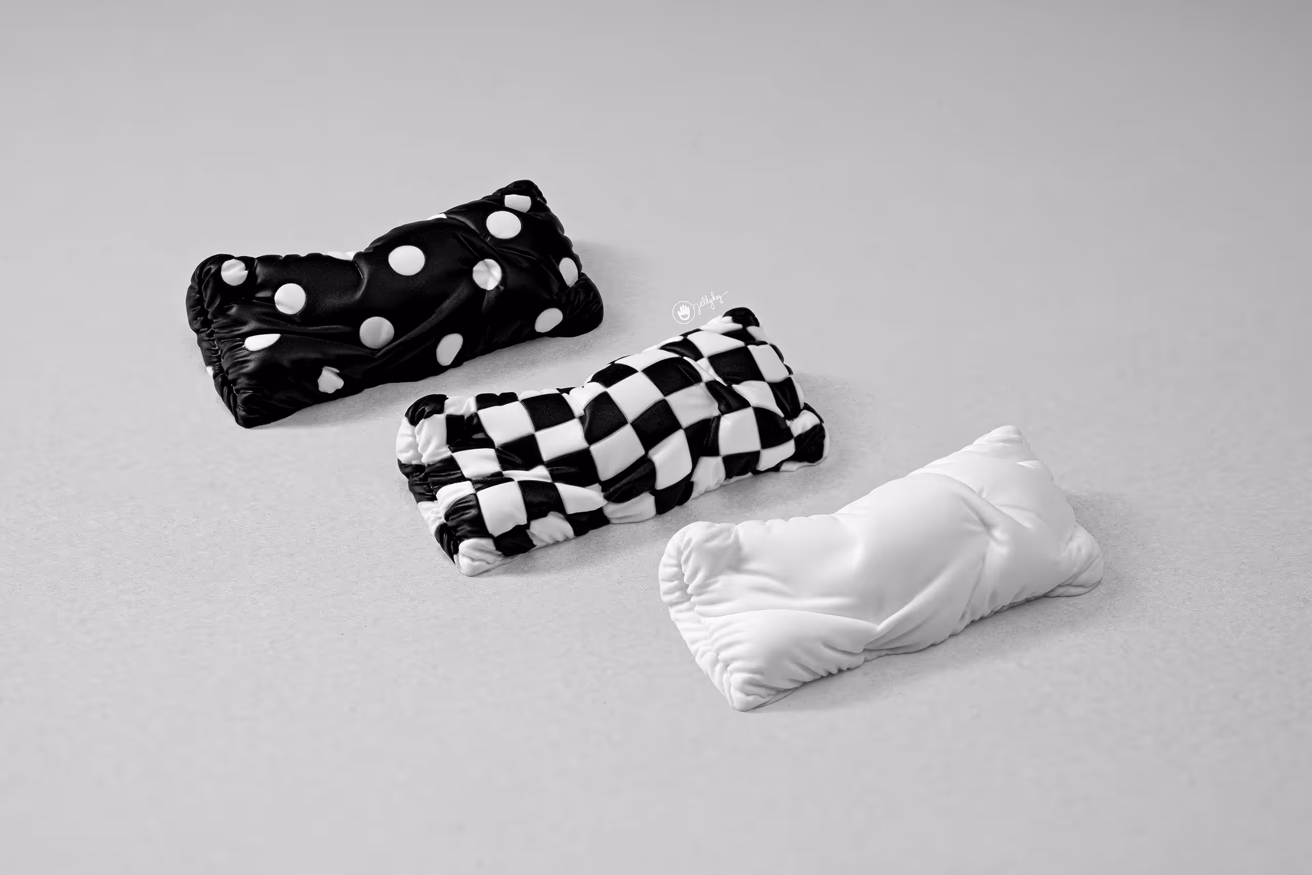 Three patterned pillow artisan keycaps on gray background.