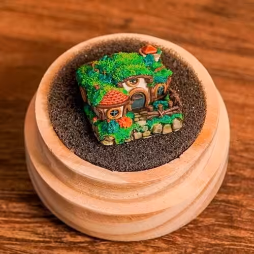 Miniature fairy house in a wooden bowl on table.