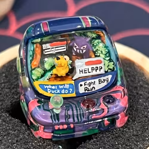 Colorful Pokémon-themed car figurine with battle scene.